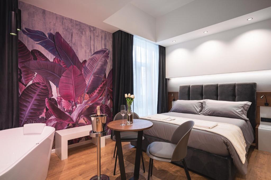 a bedroom with a large bed and a bathroom at Residenze Chamur- Grattacielo in Palermo