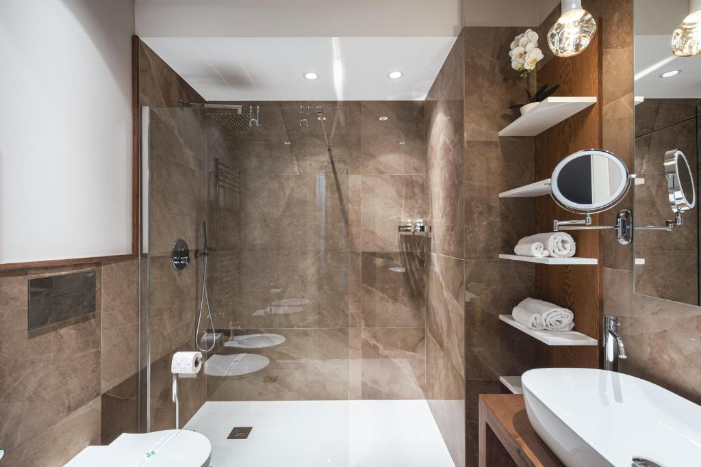a bathroom with a shower and a toilet and a sink at Residenze Chamur- Grattacielo in Palermo