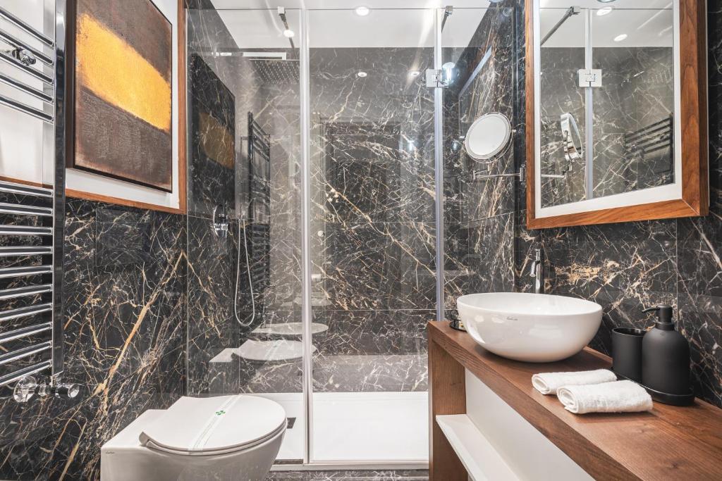 a bathroom with a shower and a toilet and a sink at Residenze Chamur- Grattacielo in Palermo