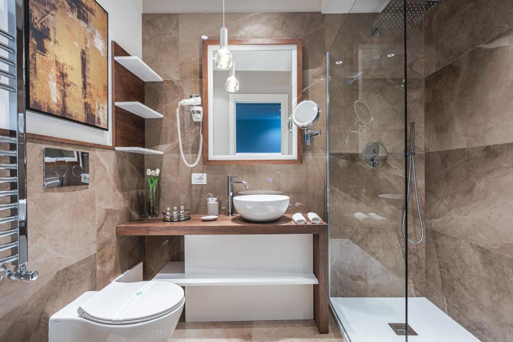 a bathroom with a shower and a toilet and a sink at Residenze Chamur- Grattacielo in Palermo