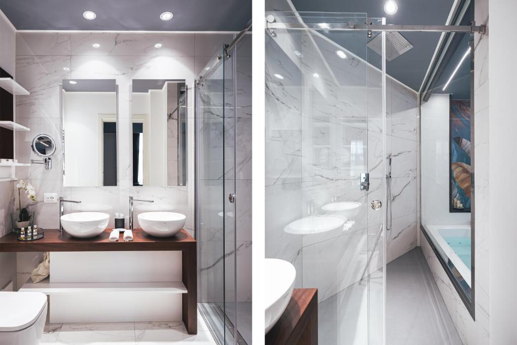 a bathroom with two sinks and a glass shower at Residenze Chamur- Grattacielo in Palermo