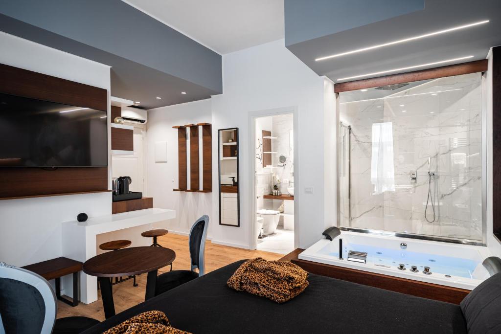 a living room with a bath tub and a room with a table at Residenze Chamur- Grattacielo in Palermo