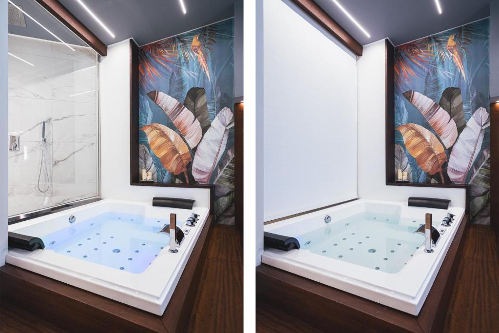 a bathroom with a tub and a painting of feathers at Residenze Chamur- Grattacielo in Palermo