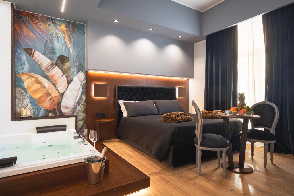 a bedroom with a bed and a table and a dining room at Residenze Chamur- Grattacielo in Palermo