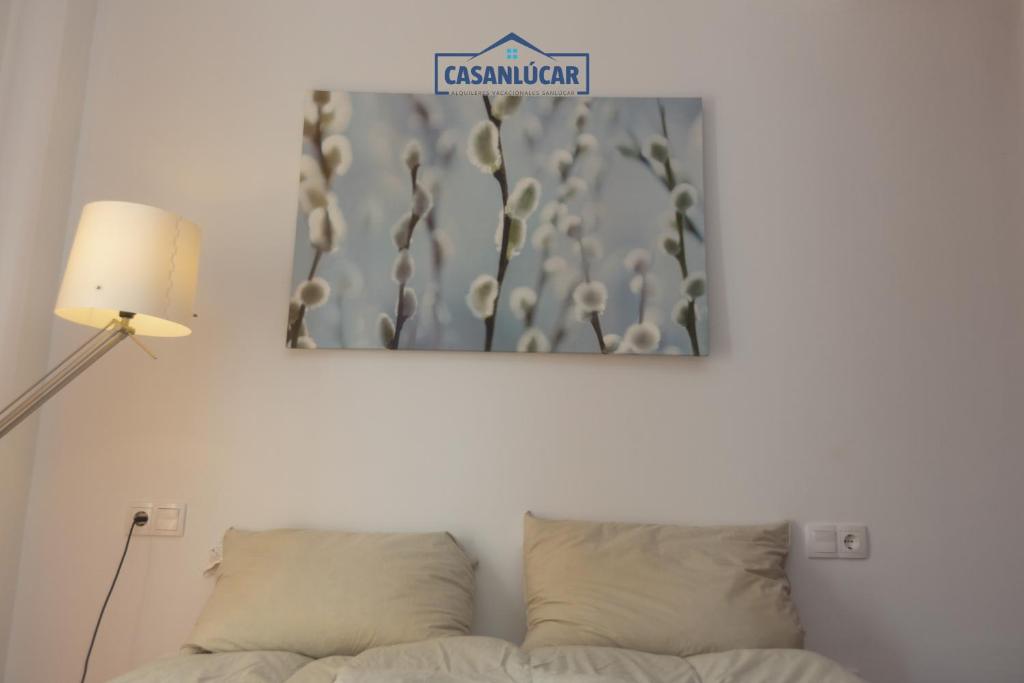 znak nad łóżkiem w pokoju w obiekcie Flamingo Golf A w mieście Sanlúcar de Barrameda