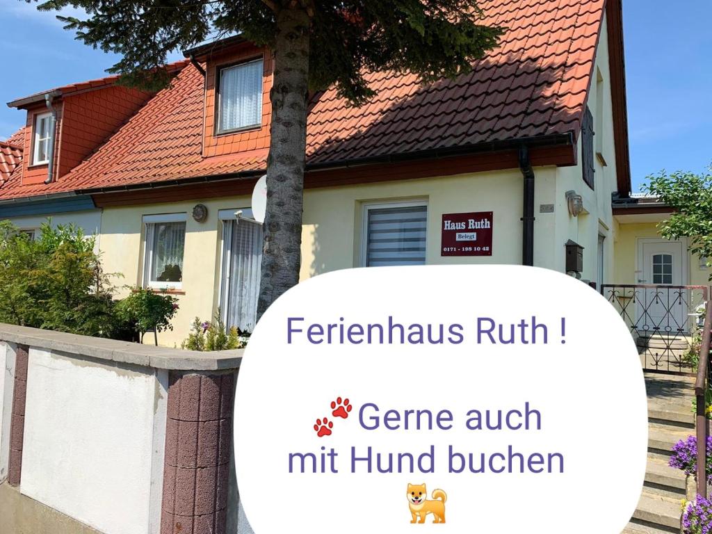 a house with a sign in front of it at Ferienhäuser Steffi und Ruth in Ueckeritz