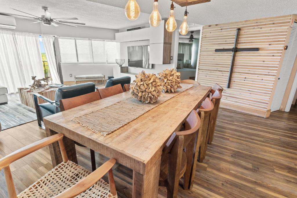 a dining room with a wooden table and chairs at TOWER 2 MASTER SUITEs, 2 KINGS BEDS, MARINA in Key Largo