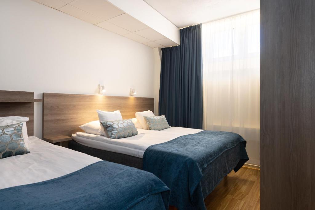 Postel nebo postele na pokoji v ubytování Hotel Söder