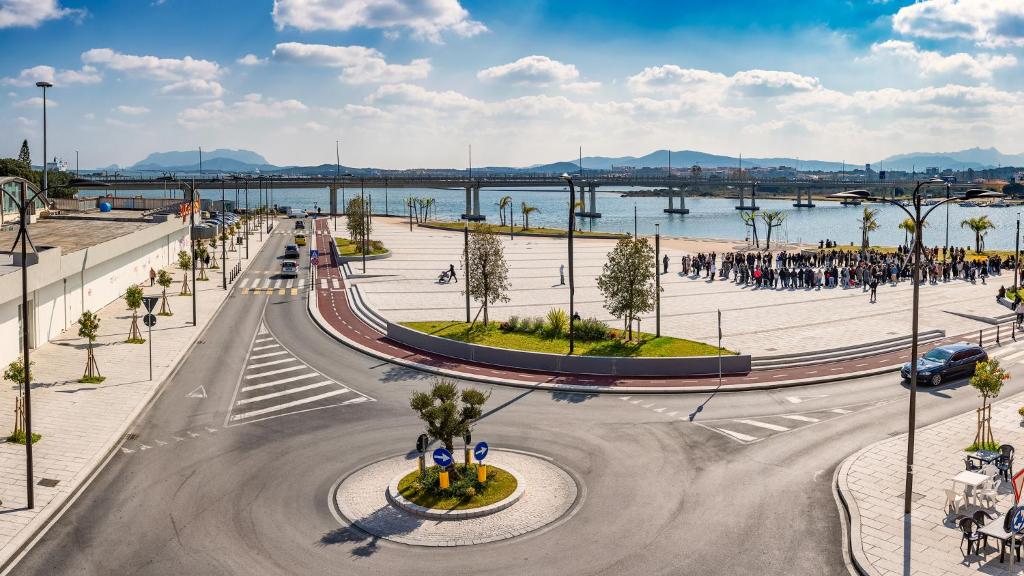 an empty street in a city with people walking around at Welcomely - Isole Apartments in Olbia