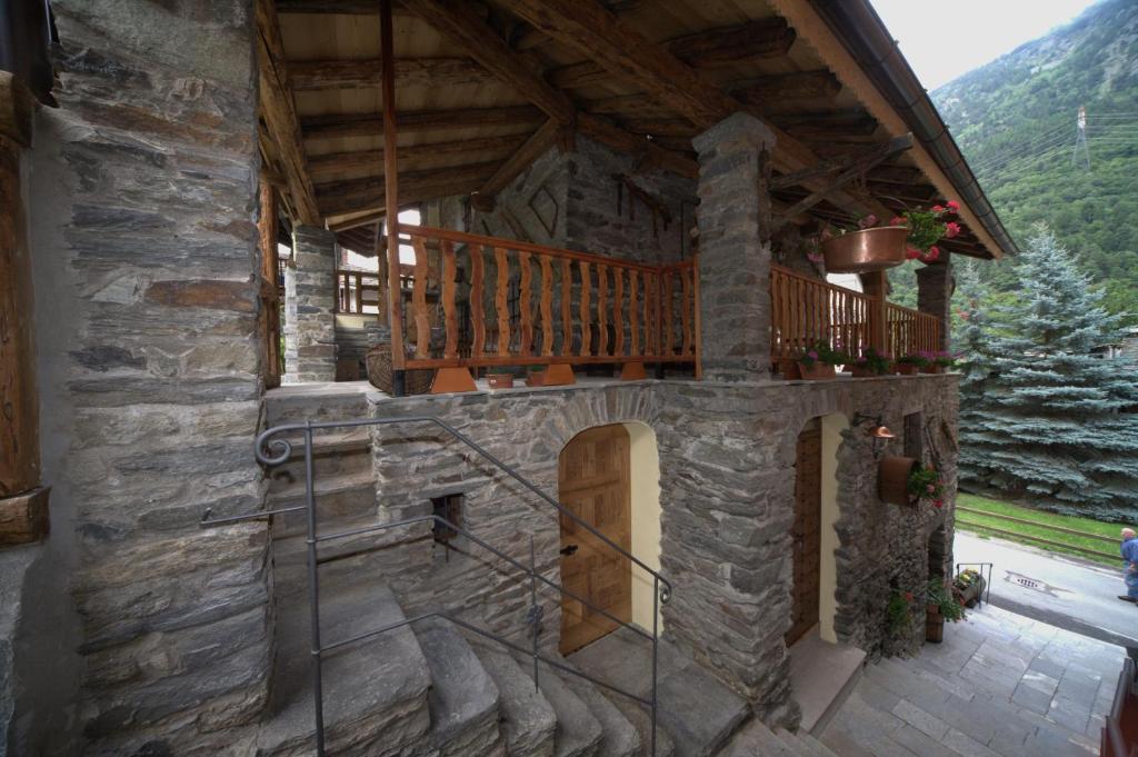 an outside view of a stone house with a balcony at La Maison Du Seigneur in La Salle