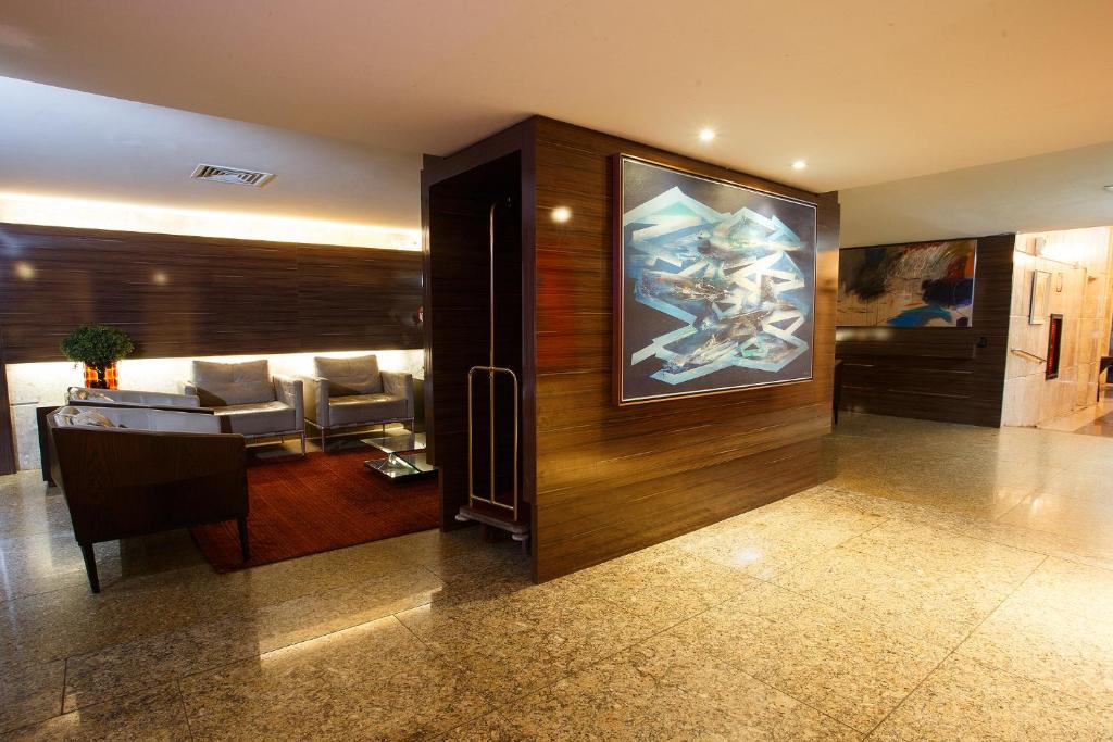 TV a/nebo společenská místnost v ubytování Savassi Hotel