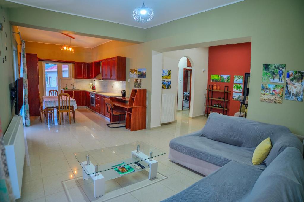 uma sala de estar com um sofá azul e uma cozinha em Mpoulakis Apartment 98 em Kissamos
