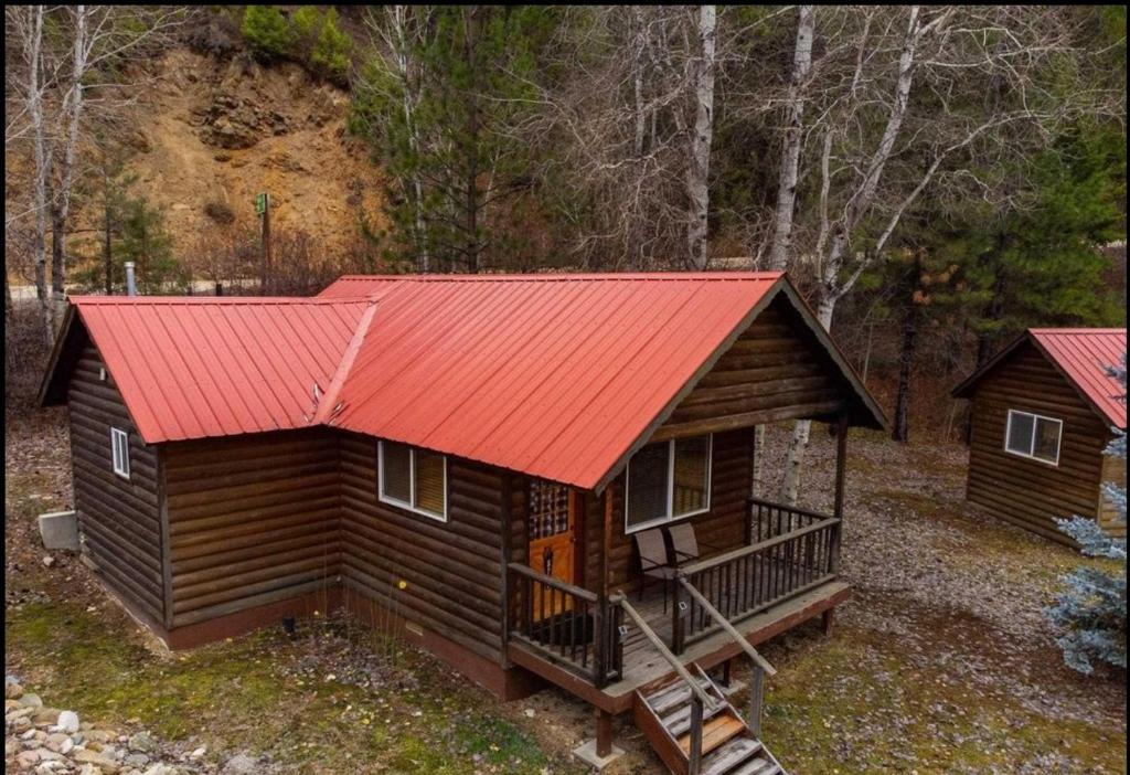 a log cabin with a red roof at Southfork Lodge Cabin 2 in Lowman