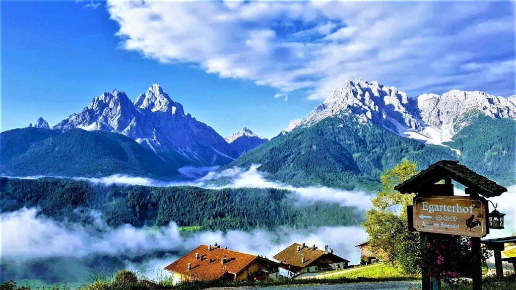 a sign in front of a mountain range at Egarterhof in San Candido