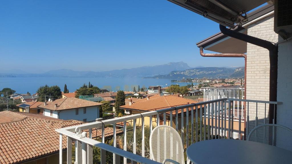 a balcony with a view of the water and buildings at PANORAMIC apartment in Bardolino