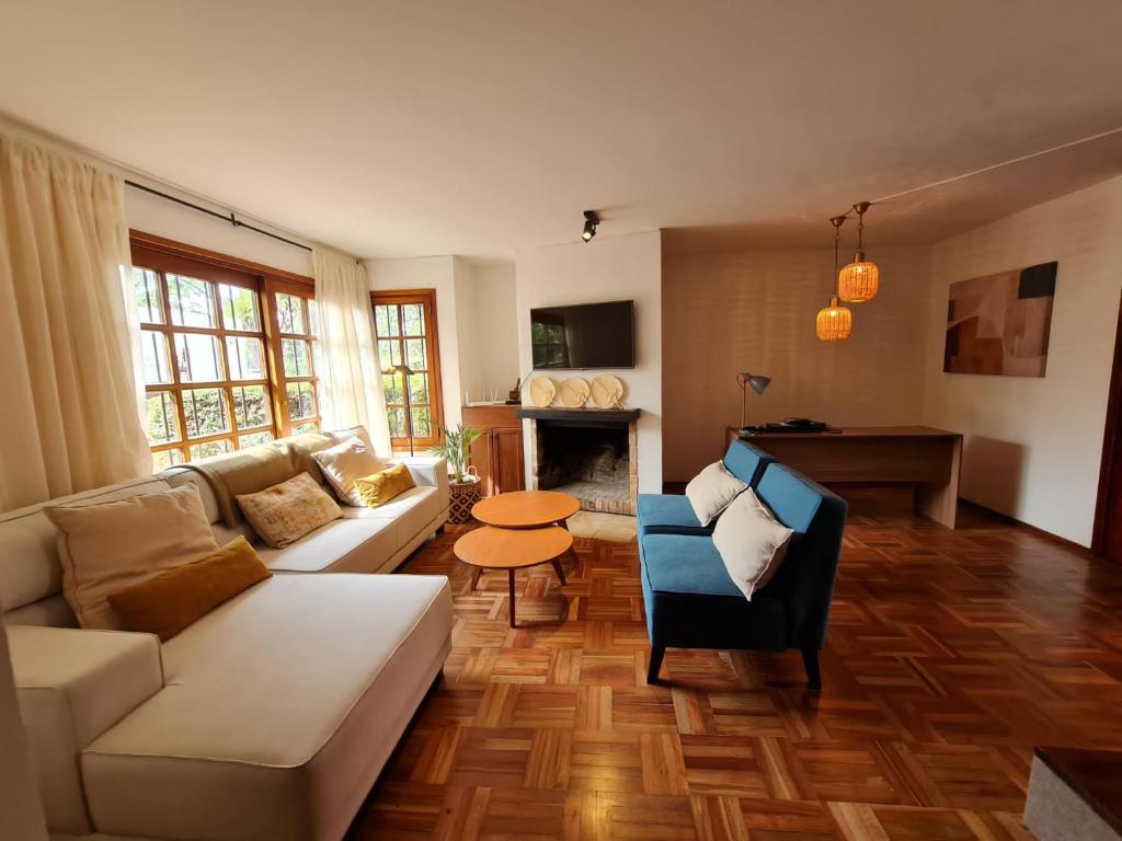 a living room with a couch and a table at Casa Carrasco in Montevideo