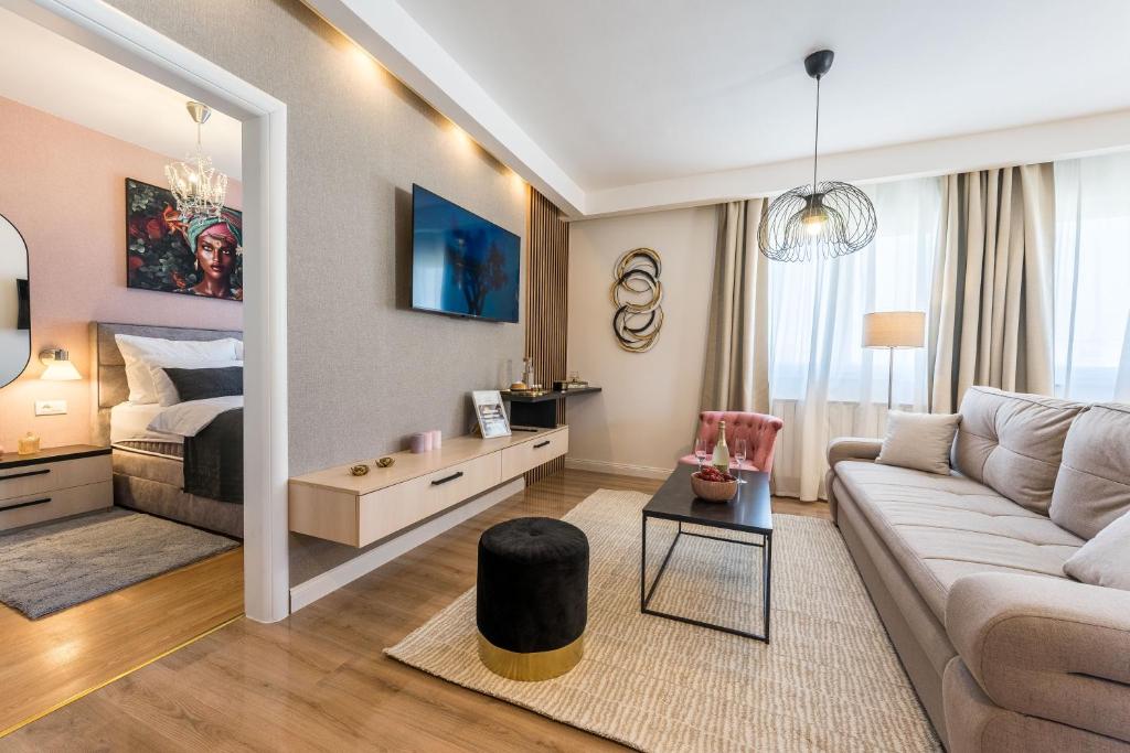 a living room with a couch and a bed at Apartment Emma with sauna in Zagreb