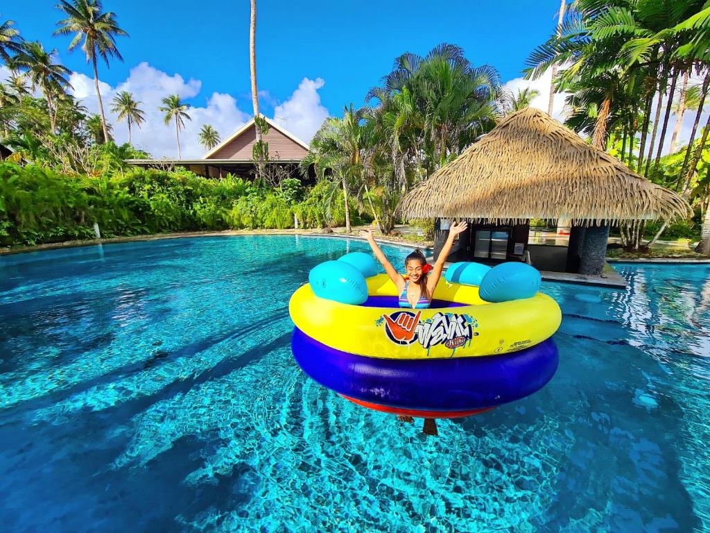 a woman in a raft in the water at a resort at Saletoga Sands Resort & Spa in Matatufu