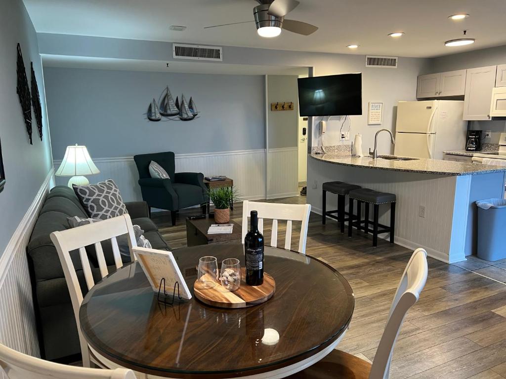 a dining room and living room with a table and chairs at 2 Bed 2 Bath Beach Front Condo with Fantastic Amenities at Myrtle Beach Resort in Myrtle Beach