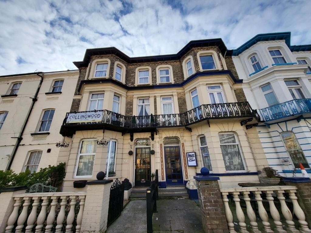 a large house with a fence in front of it at The Collingwood Guest House in Great Yarmouth