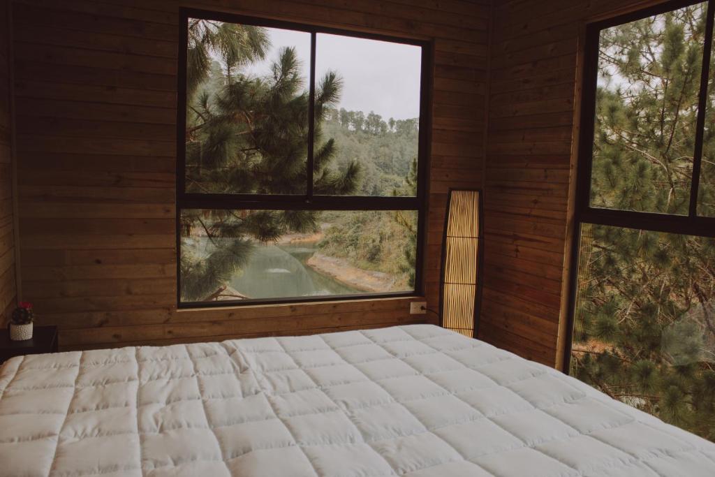 Cama o camas de una habitación en Cabañas Refugio Himalaya