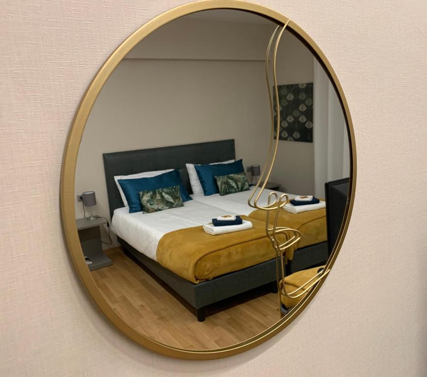 a bedroom with a bed and a mirror on the wall at Palazzo dei Notai in Bologna