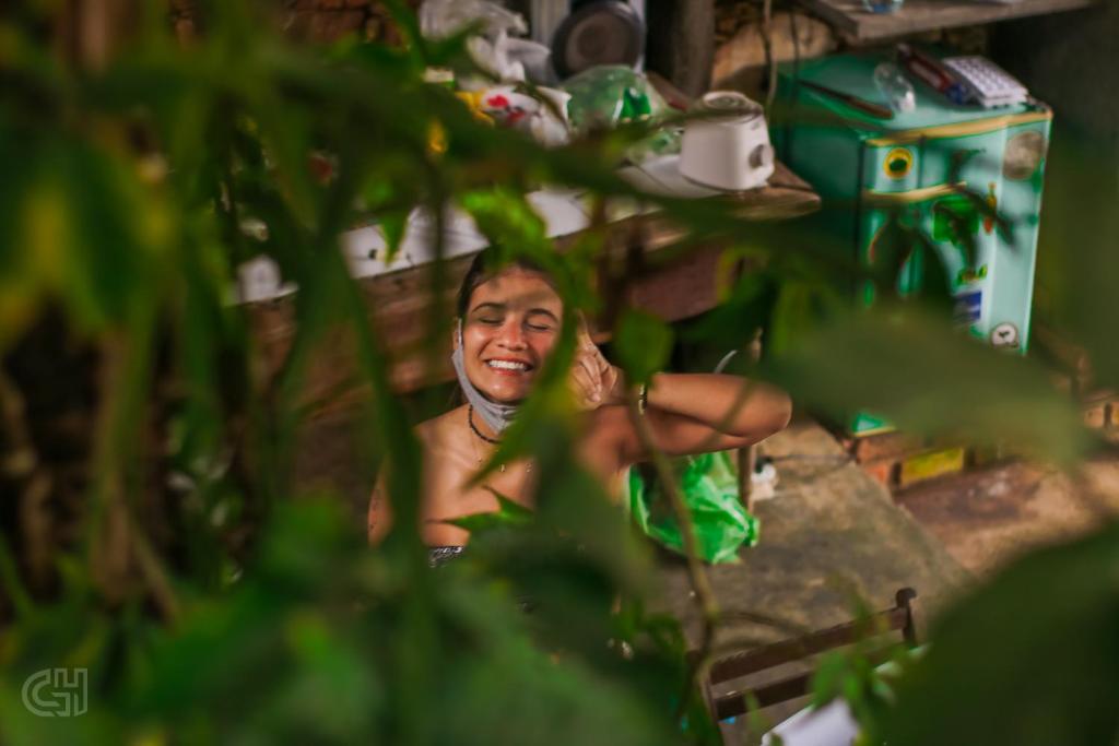 a man is sitting in a room with at Hostel Andarai in Andaraí