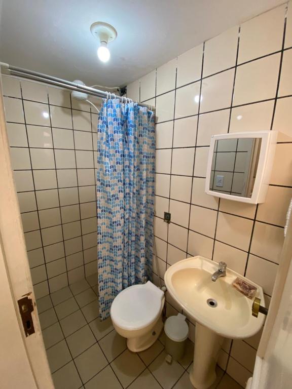 a small bathroom with a toilet and a sink at Cantinho do SOSSEGO, a 2 km da praia de Itapuã, no centro da cidade, wifi, ideal para CASAL in Vila Velha