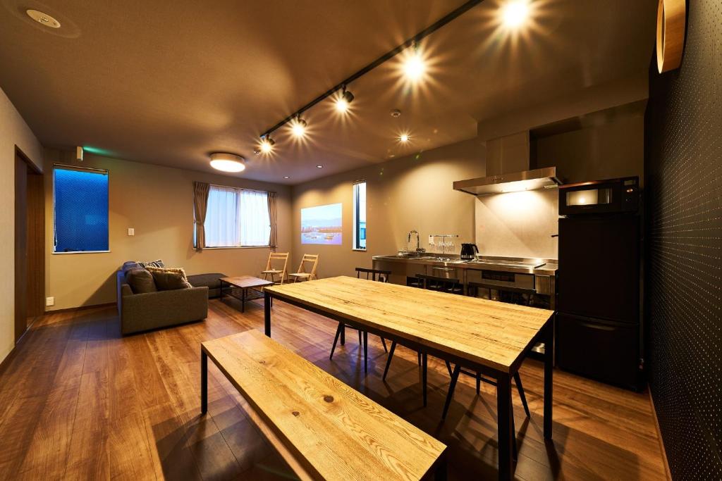 a living room with a table and a kitchen at Rakuten STAY HOUSE Kisarazu in Kisarazu