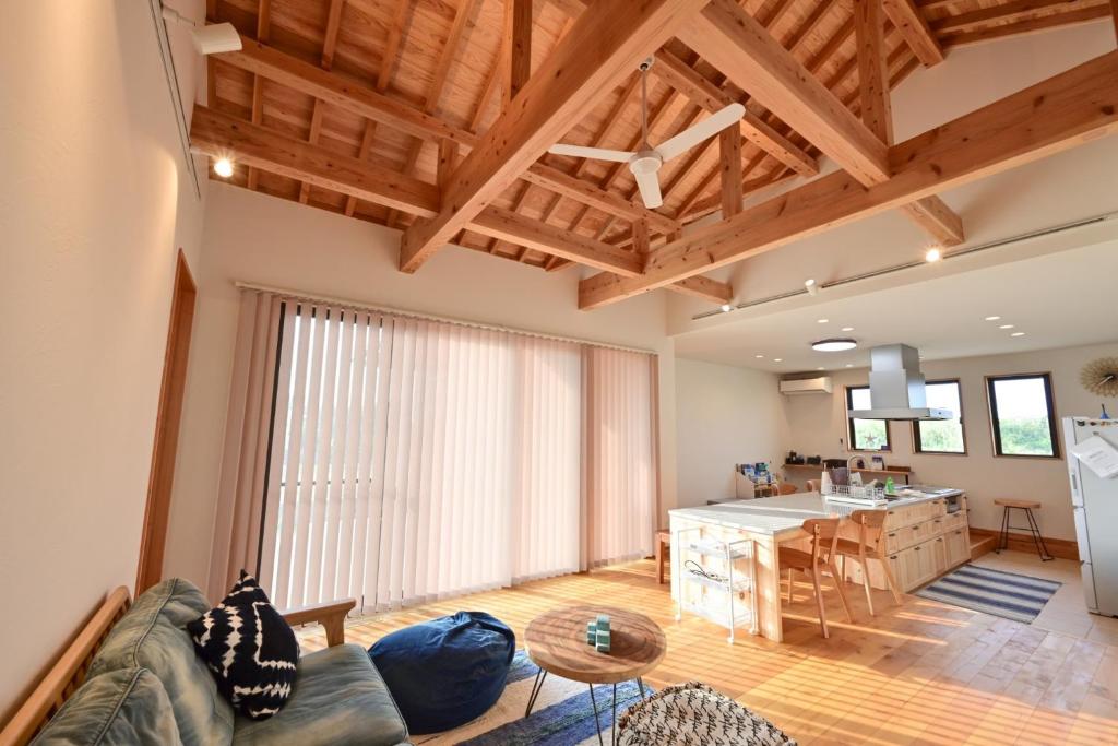 a kitchen and living room with wooden ceilings at Ishigaki Island Villa 7716-Vacation STAY 72439 in Ishigaki Island