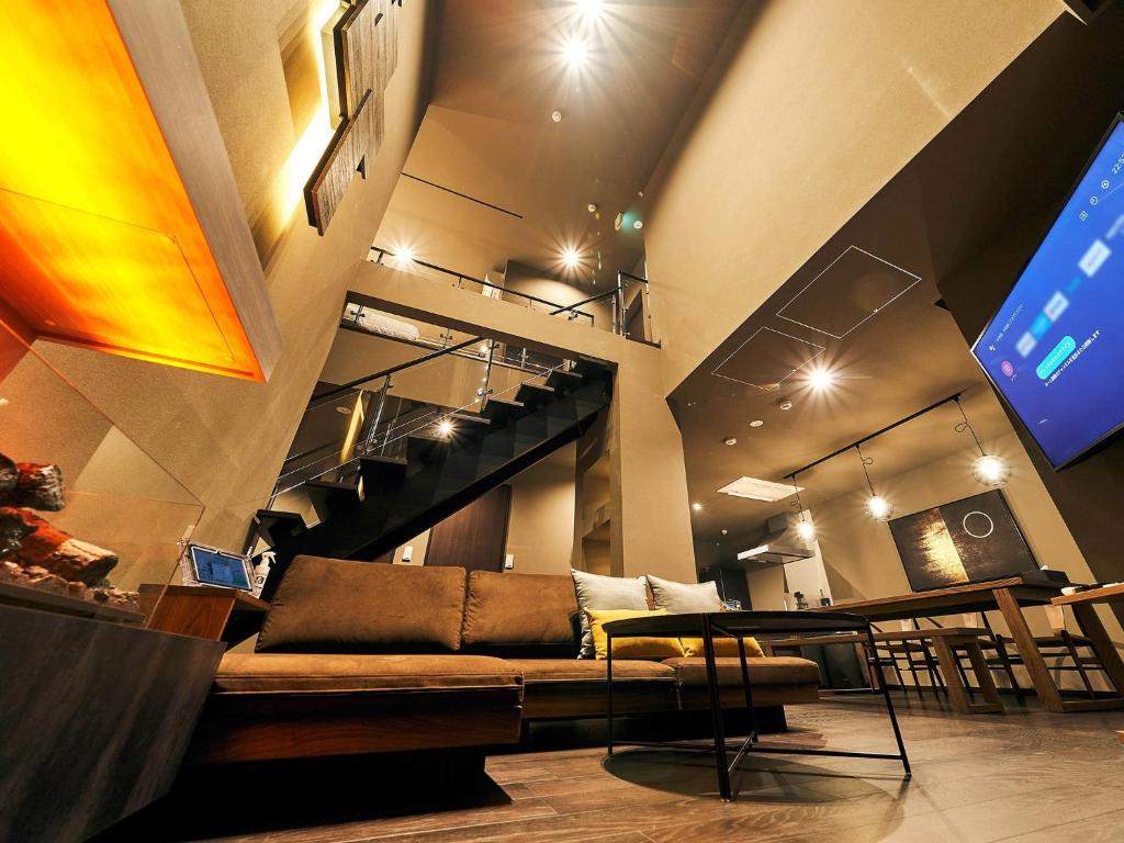 a living room with a couch and a table at Rakuten STAY VILLA Hakone Sengokuhara North Wing 101 or 103 BBQ terrace Capacity of 10 persons in Hakone