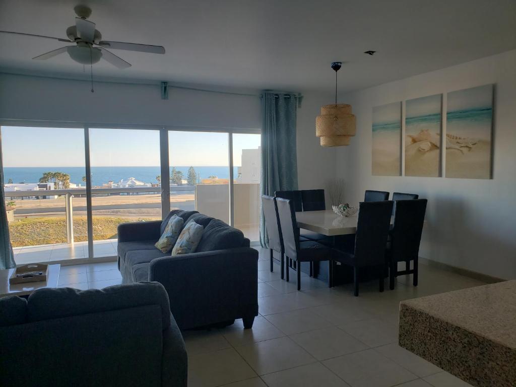 uma sala de estar com um sofá, uma mesa e cadeiras em Corona Del Sol 1104, Puerto Peñasco, Las Conchas em Puerto Peñasco