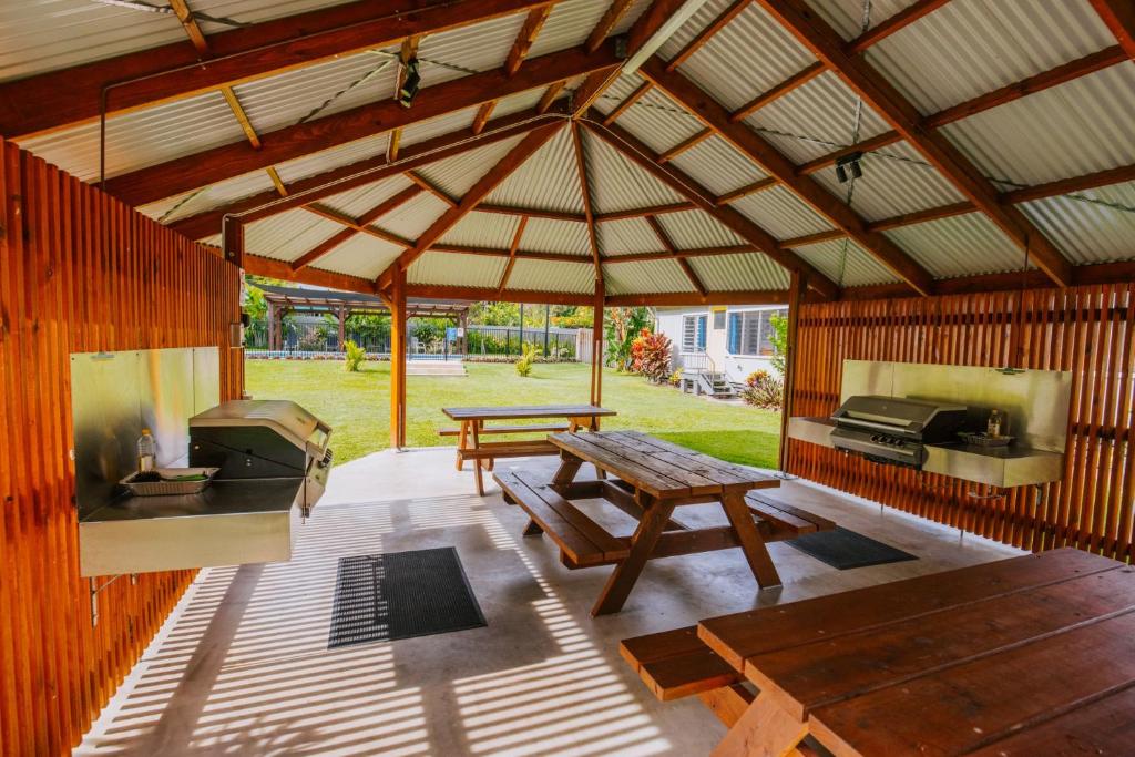 a large wooden pavilion with a picnic table and a grill at Kooyong Apartment 7 in Arcadia