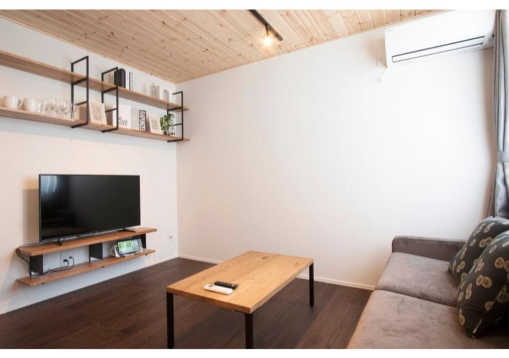 a living room with a couch and a table at Rakuten STAY HOUSE x WILL STYLE Fujiyoshida Matsuyama 101 in Fujiyoshida