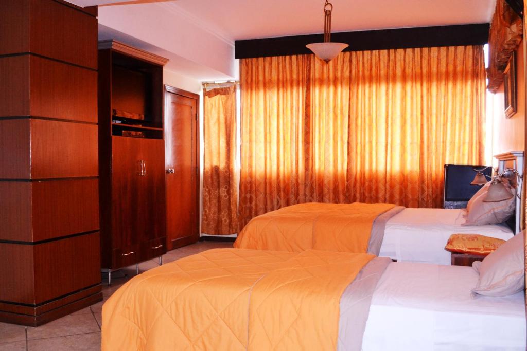 Postel nebo postele na pokoji v ubytování Hotel Malecon Inn