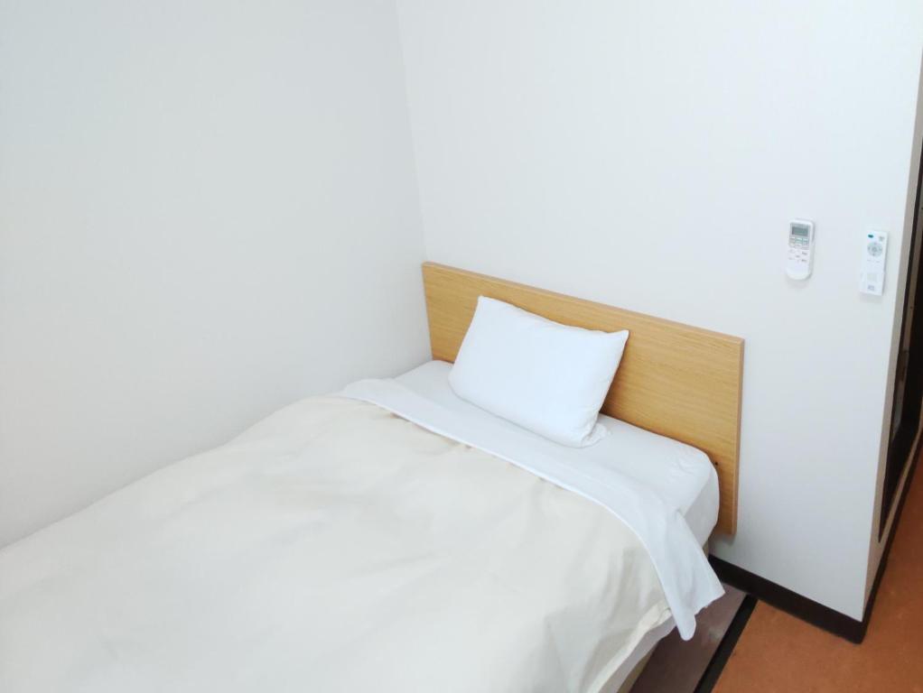 Postel nebo postele na pokoji v ubytování Hotel Hakusan Hills