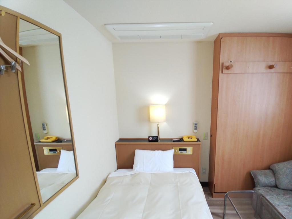 Postel nebo postele na pokoji v ubytování Hotel Hakusan Hills
