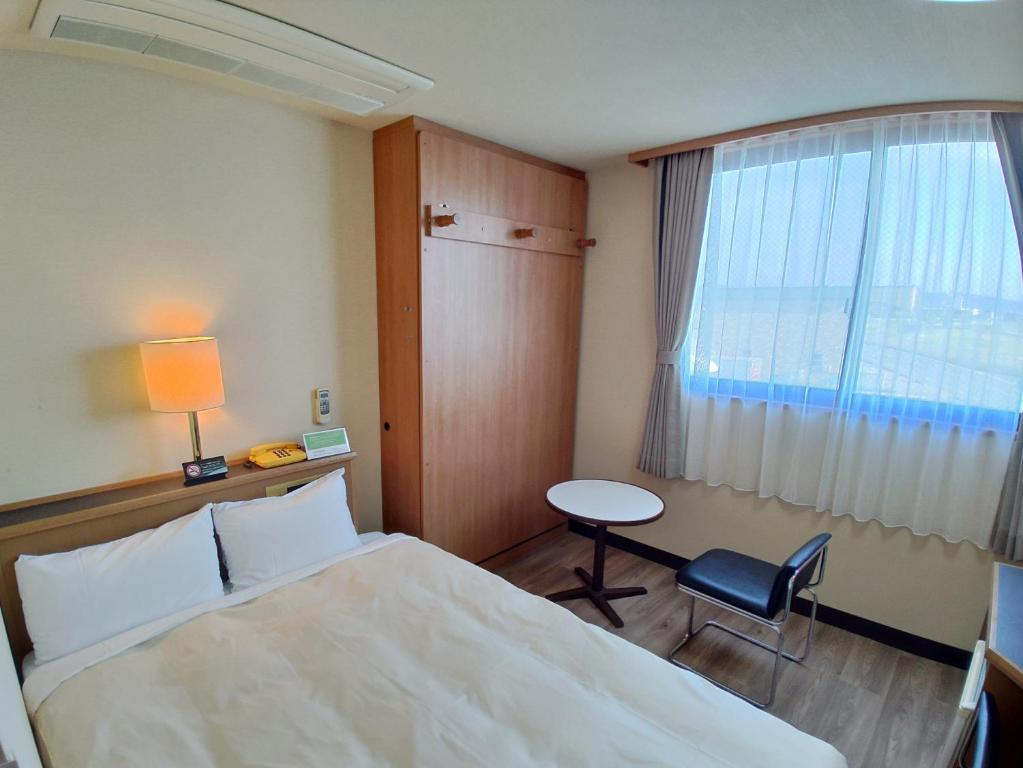 Postel nebo postele na pokoji v ubytování Hotel Hakusan Hills