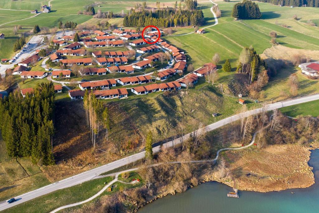 an aerial view of a village with houses next to a river at Ferienhaus Nr 102, Kategorie Komfort, Feriendorf Hochbergle, Allgäu in Karlsebene