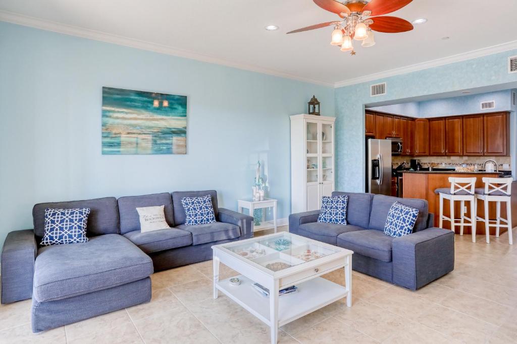 a living room with two couches and a table at Bayfront Bounty in Clearwater Beach