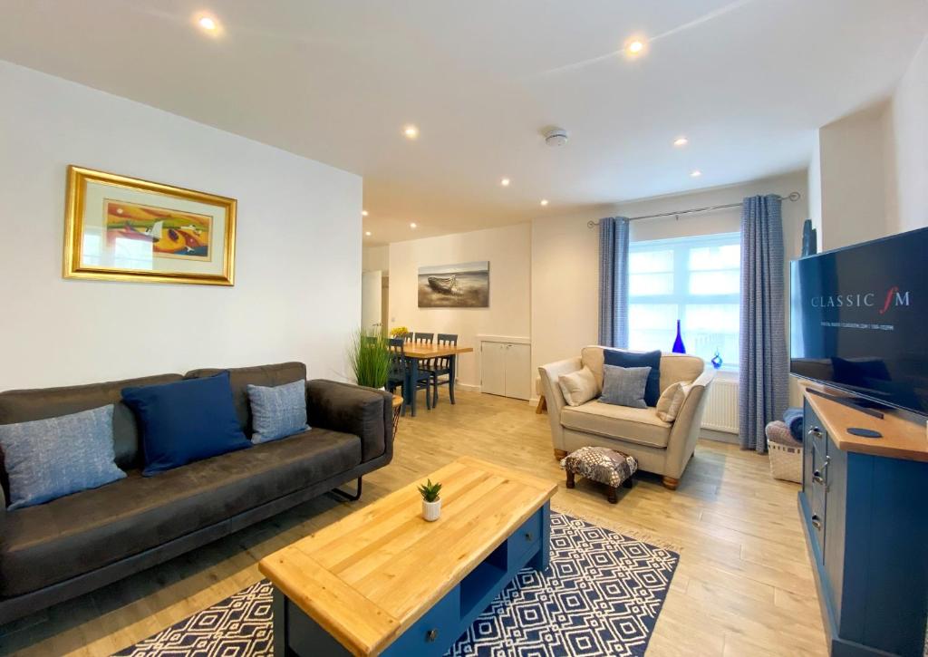 a living room with a couch and a table at No2 Ellington Court Apartment in Torquay