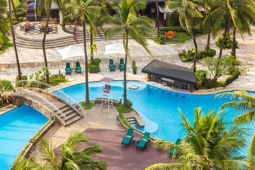 an overhead view of a resort pool with palm trees at Sofitel Philippine Plaza Manila in Manila