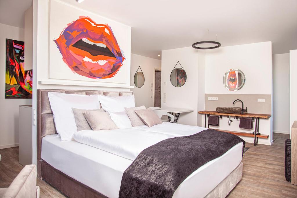 a bedroom with a large white bed and a table at The Faces Berlin in Berlin