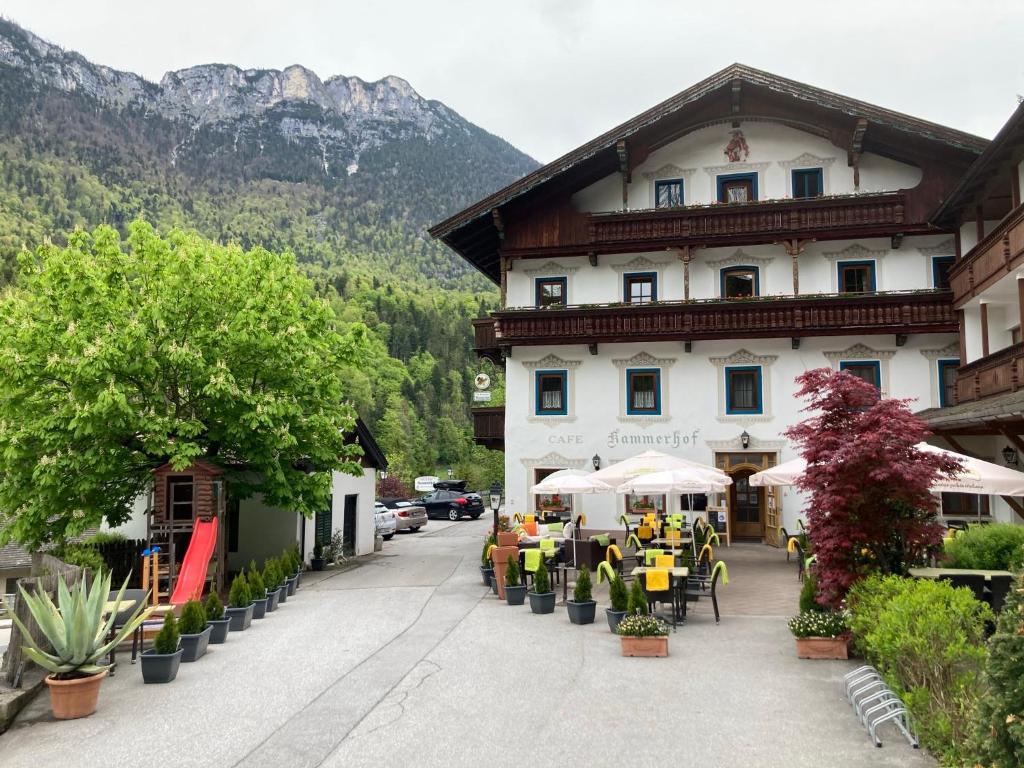 a large building with tables and chairs in front of it at Hotel Kammerhof in Mariastein