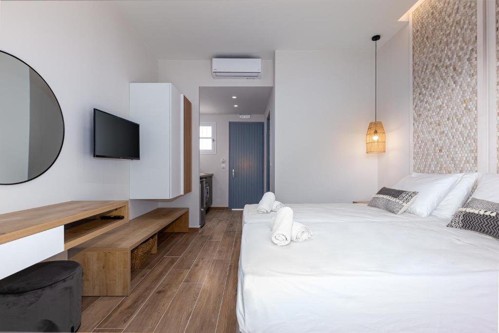a hotel room with two beds and a tv at Sea View in Paleokastritsa