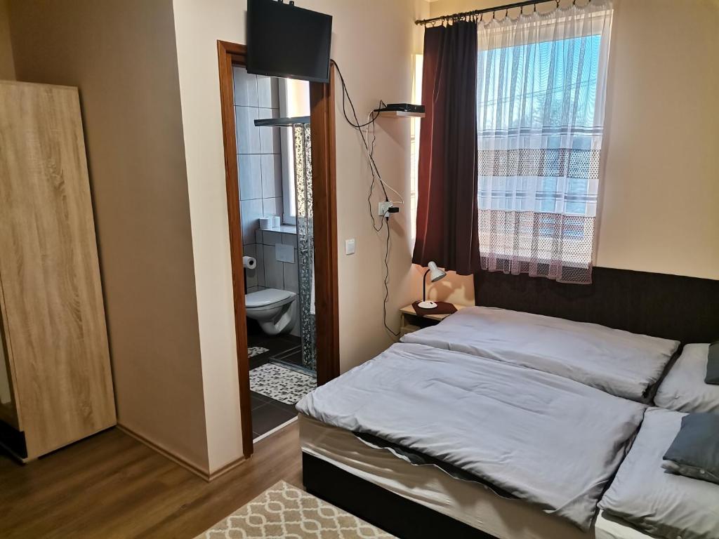 Postel nebo postele na pokoji v ubytování Ókerka Vendégház