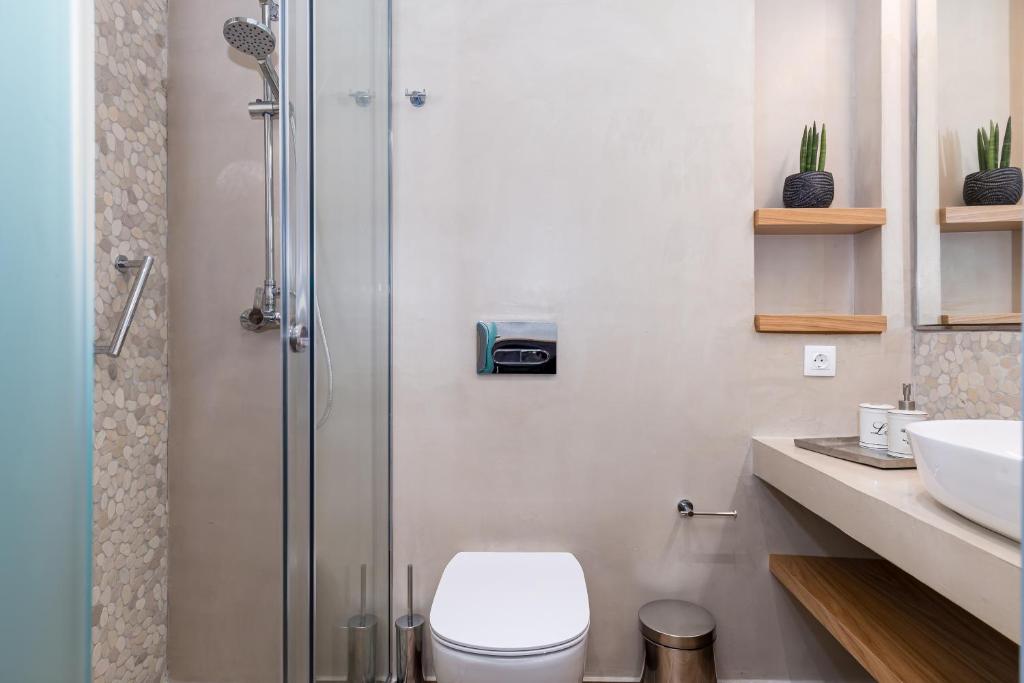 a bathroom with a shower and a toilet and a sink at Sea View in Paleokastritsa