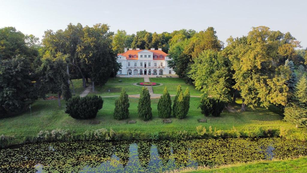 an aerial view of a mansion with a pond and trees at Dwór Zbożenna in Przysucha