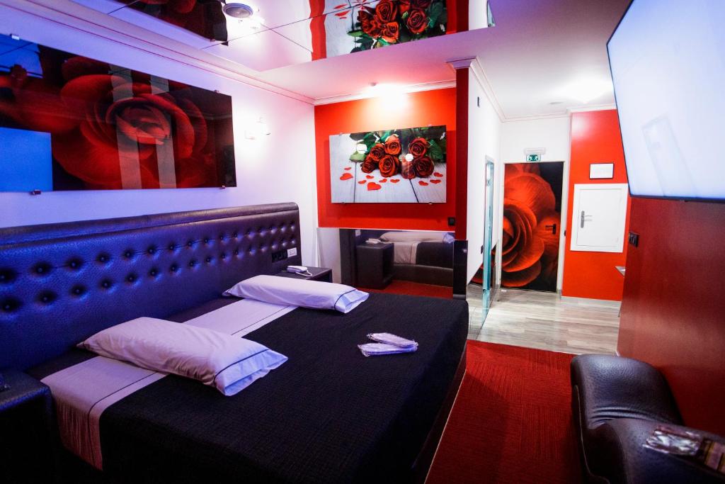 a room with a bed in a room with paintings at Motel Venus Santiago in Santa María