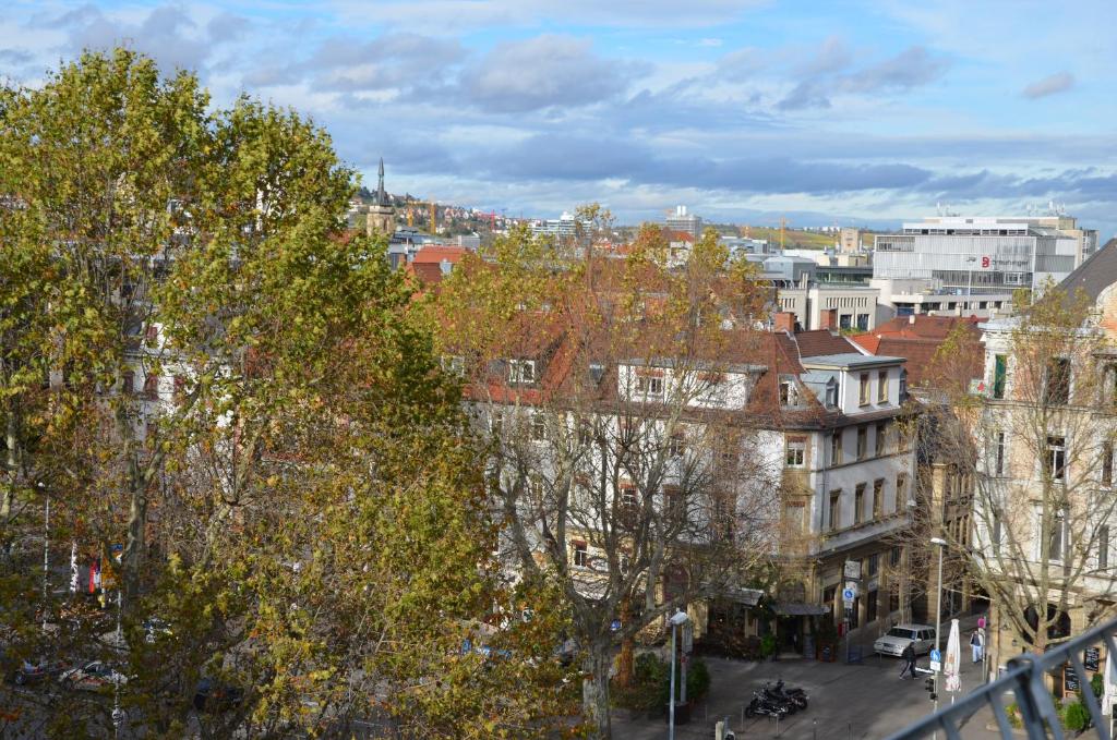 Blick auf eine Stadt mit Bäumen und Gebäuden in der Unterkunft Hotel am Wilhelmsplatz in Stuttgart